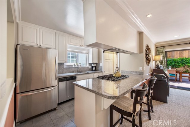 Remodeled kitchen with granite counters, tile flooring, a pantry and stainless steel appliances