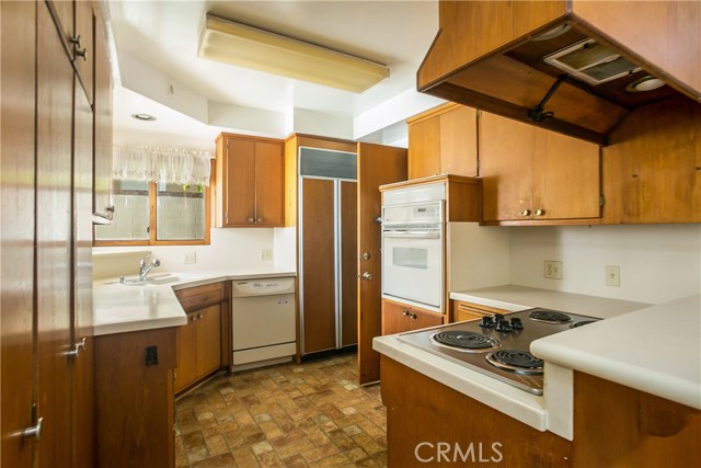 The kitchen has good storage and counter areas, a subzero refrigerator and a doorway leading out to the rear patio.