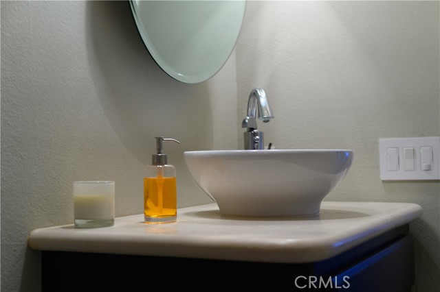 Second bathroom sink and cabinet, topped with soapstone
