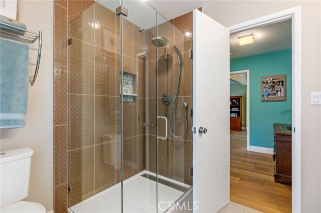 Master bathroom has large shower w/ frameless glass enclosure, floor to ceiling tiled shower and floors.