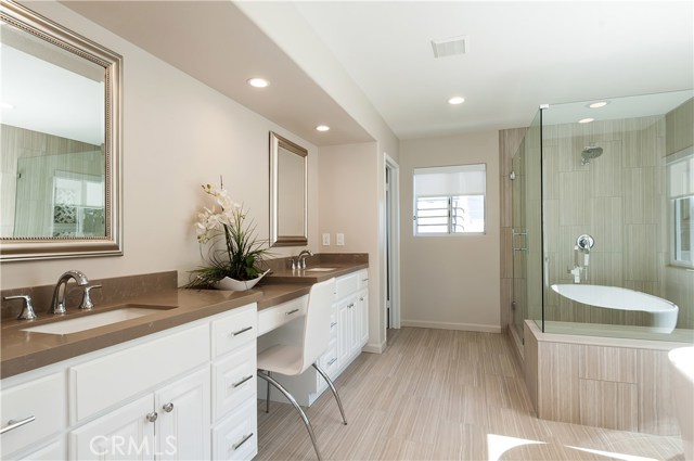 Master bath with double vanity, oversized stall shower and free standing tub