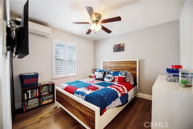 3rd bedoom with wide plank flooring, lots of light, plantation shutters, new lighting and air conditioning