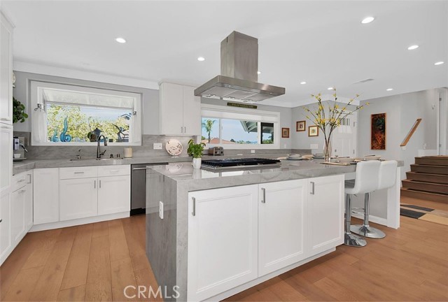 High-end porcelain waterfall counters add a touch of style to the already practical kitchen