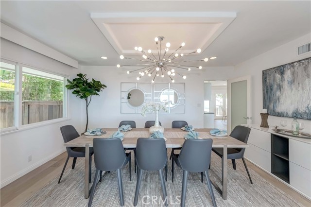 Dining room with Hunter Douglas window shades.