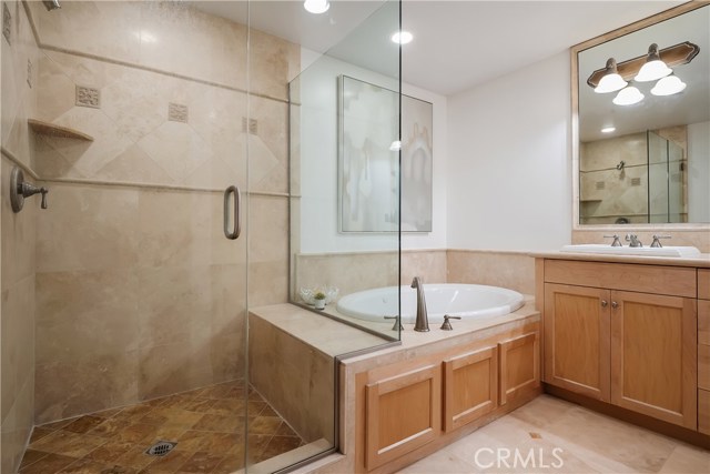 Primary en-suite bathroom with separate shower and luxurious bath tub.