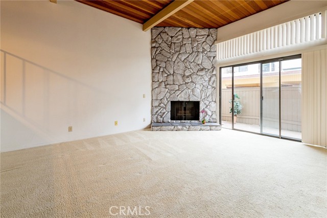 For perspective, this photo is a neighboring unit with no furniture. Ceiling in 852 1st St has been painted white and flooring is wood-look, not carpet.