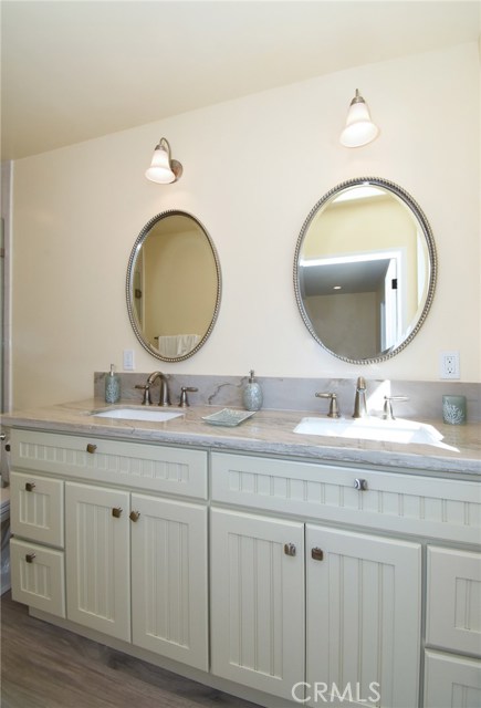 Great guest bath with new cabinets, counters, mirror, lighting and beyond this shot are a great new shower and commode.