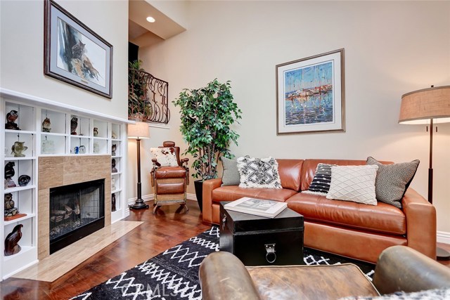 Custom built-ins and travertine fireplace create a cozy feel for this formal living room.