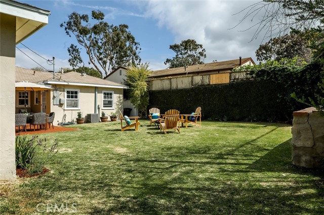 Another view of large grassy area in backyard