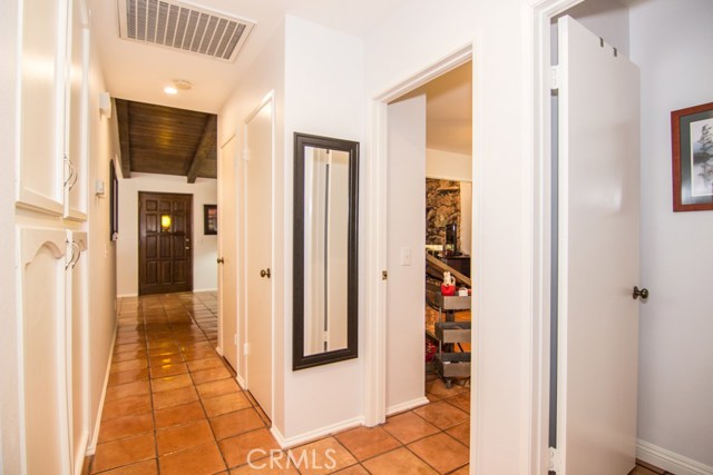 NICE WIDE HALLWAY WITH CABINETS FOR STORAGE.