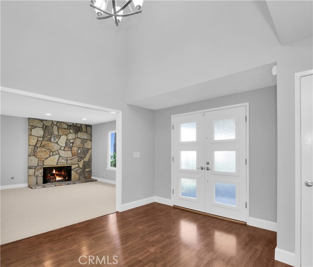 Foyer view toward living room (fire is photographer's graphic insertion, not real) Foyer view toward living room (fire is photographer's graphic insertion, not real)