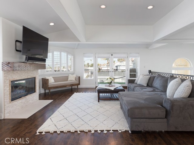 Top floor living area with gas fireplace and access to balcony