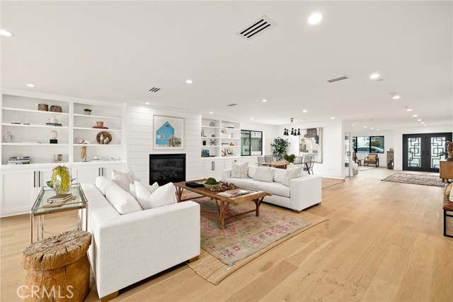 Open Floor Plan With Alluring Fireplace And Surrounding Custom Focal Wall