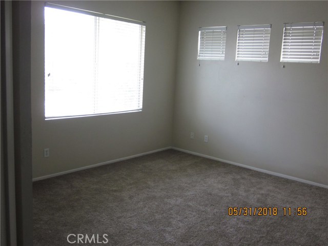 Master bedroom with plenty of windows and light.