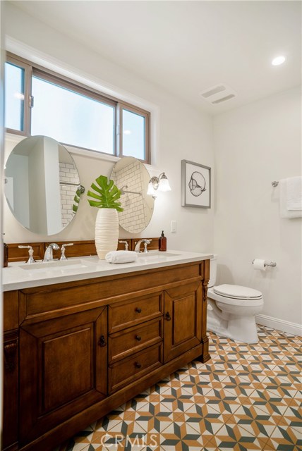This is the downstairs completely remodeled full bath. The mirrors are adjustable and the lighting and windows allowing the natural light make this a delightful retreat.