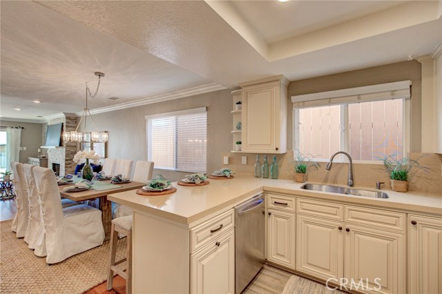Spacious dining area with a chic brand new chandelier and a lovely breakfast bar