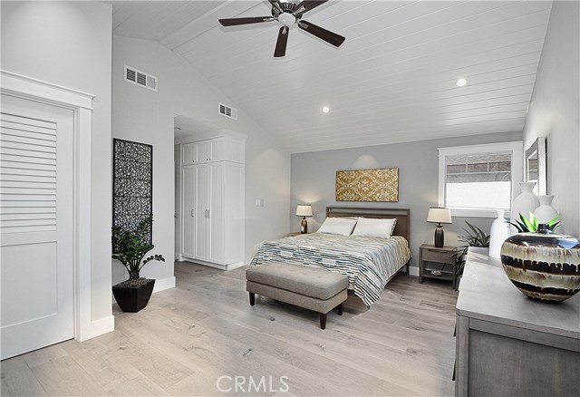 Master bedroom with vaulted ceiling, skylight and a ceiling fan. Walk-in closet on the left and linen closet at the entry