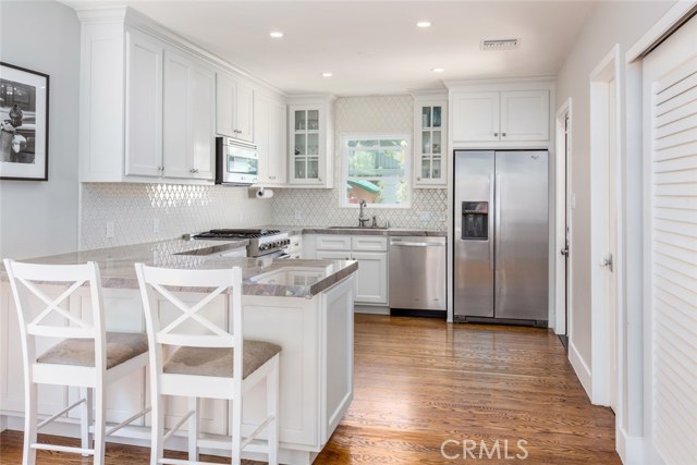 Gorgeous, gourmet kitchen, with a huge pantry/laundry room conveniently situated behind sliding louvered doors (to the right)