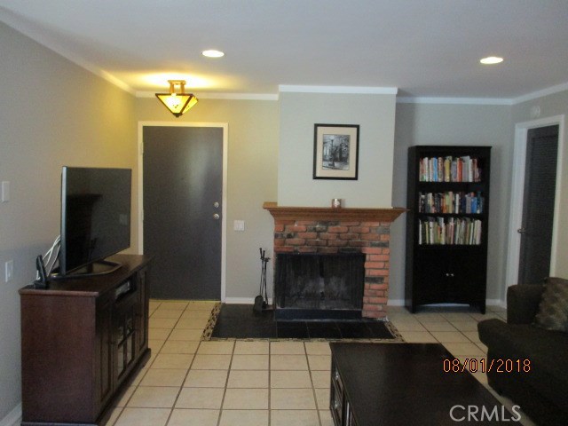 View while pointing at fireplace and entry door from balcony.