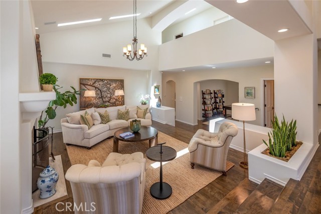 light and bright living room with skylights, volume in ceilings