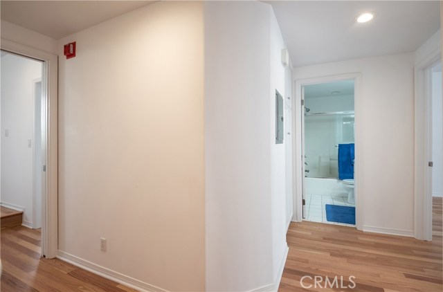 Hallway with new hardwood flooring to the bedrooms and second bathroom