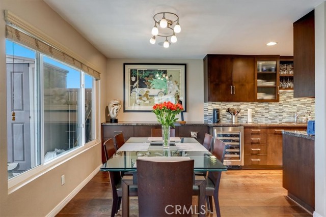 Great shot showcasing the extra long counter and cabinet space off of the kitchen and the extra wide wine fridge...Salud!