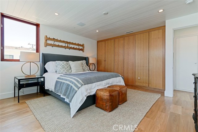 Master suite includes walk-in closet and additional cabinetry behind rift-sawn oak panels