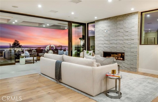 Pocket sliding glass doors open to create a seamless indoor/outdoor space with a west facing view