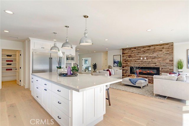 Massive Caesarstone island, tons of storage cabinets, huge walk-in pantry, opens to large family room.  Tons of natural light.