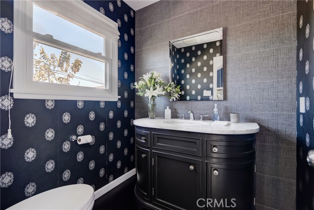 Exquisite powder room adjacent to the great room with it's custom curved cabinetry.