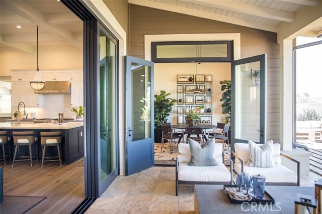 Elegant, relaxed and welcoming covered patio shows the enviable indoor-outdoor lifestyle at Chadmar's Residences of Rolling Hills Country Club. Model home shown.