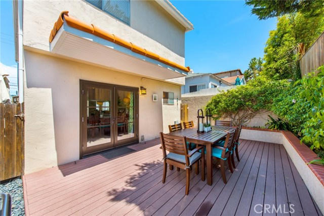 Great outdoor space with redwood deck and beautifully landscaped planters