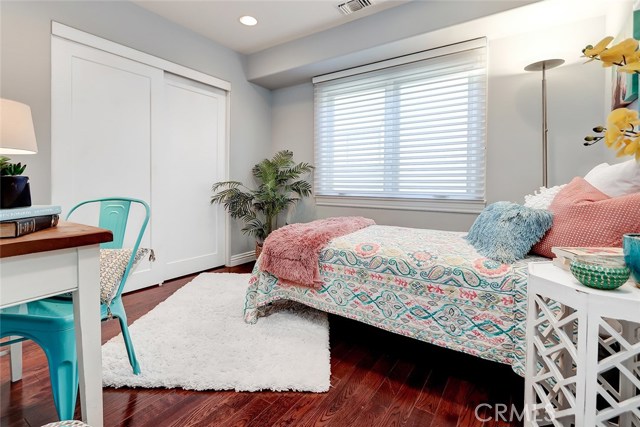 3rd bedroom with custom window treatments and sliding closet doors can be used for kids, guests, or as an office!