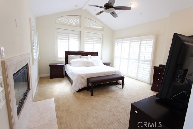 Master bedroom, fireplace, plantation shutters on skylights too! for personalized ambient light. His and her night lighting, Ceiling fan on vaulted ceiling. Balcony opposite fireplace.
