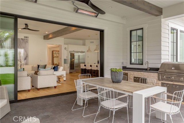 back patio with built-in BBQ and stainless steel drawers, storage and built in trash receptacle