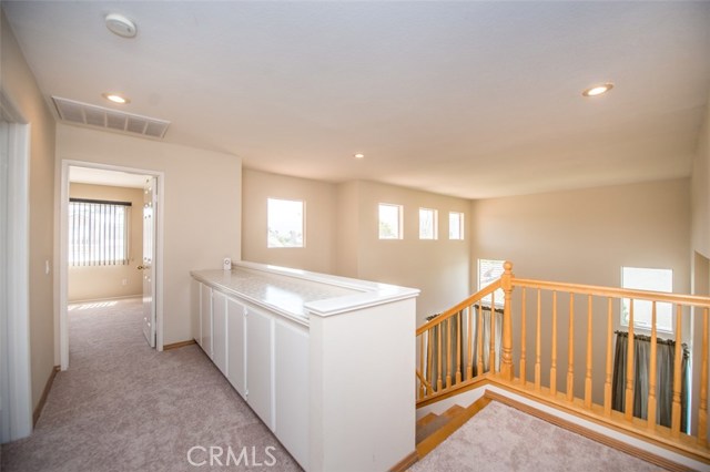 Upstairs hallway w/ build in linen cabinets and new carpet