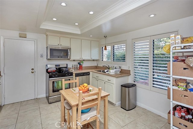 Recessed lights, new cabinets with crown molding, tile and countertops, as well as shutters were added to this home.
