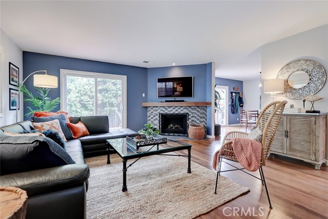Open concept floor plan with spacious living room and fireplace with newly installed tile front.