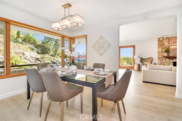 Formal dining room between the living room and kitchen with large view windows.