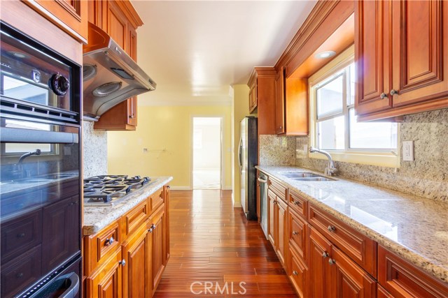 The kitchen is situated between the formal dining room and the den/eating/entertainment area. Laundry Room and Master Bedroom are also adjacent.