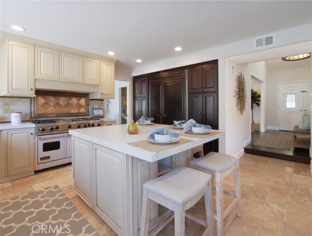 Kitchen with center island and built-in refrigerator