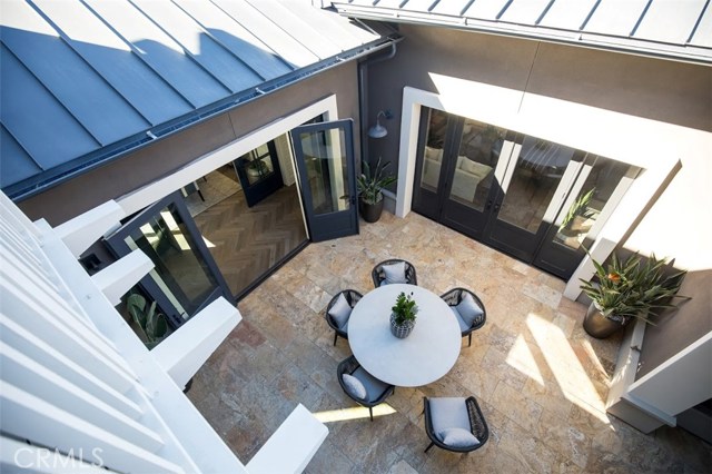 One of two private courtyards that open up to enjoy the indoor-outdoor lifestyle with friends and family. Model home shown.