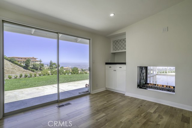 Fireplace, dry bar with wine rack and access to backyard.