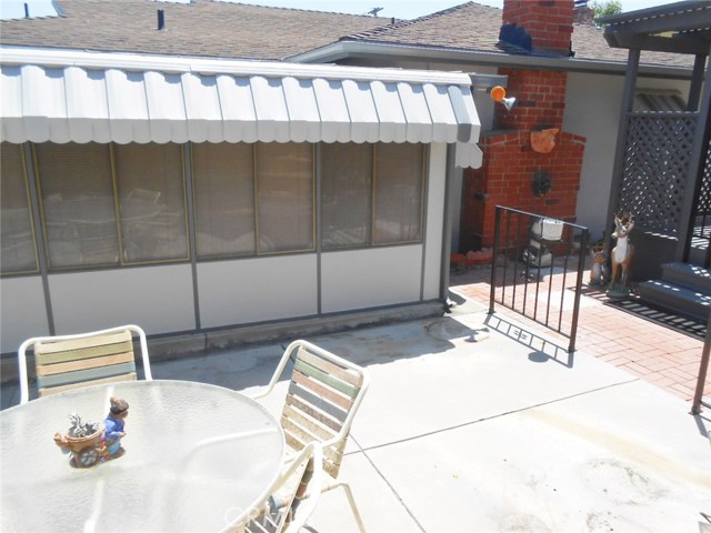 Back of Enclosed Patio Exterior View and Awning to help Keep Inside Room Temperature Cooler.