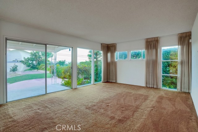 Living Room with large picture slider onto patio and back yard area.