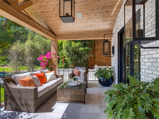 Front porch - Solara natural gas porch lamps, LaCantina door systems, surround sound on porch, sandblasted marble entry tiling, dutch door, security cameras.  Green belt and Sand Dune park only steps away.