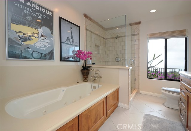 Spa tub, oversized shower and double vanity sinks.