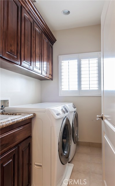 The laundry room includes plenty of storage.