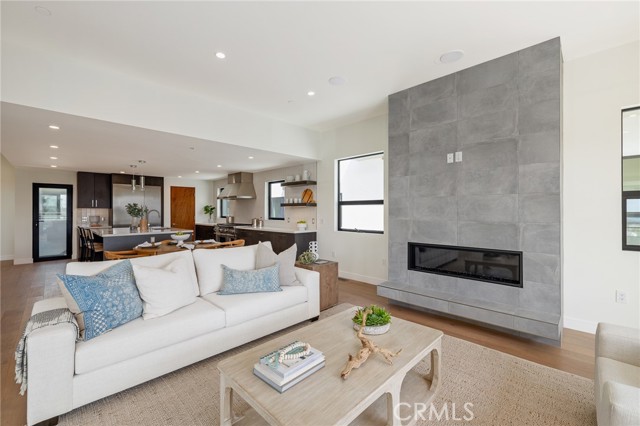 Statement floor to ceiling fireplace anchors the spacious living area (shown here using reverse of 961 Unit A staging)