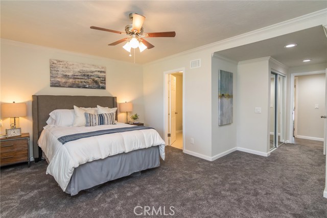 The spacious master bedroom features new carpet, a new ceiling fan and great views of the pool.